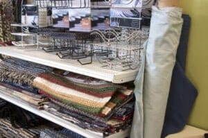 shelf of throw rugs at Goodwill store